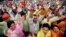 Cambodians raise their arms as they gather during a protest at Freedom Park in central Phnom Penh, Dec. 17, 2013.