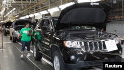 FILE - A Chrysler auto assembly worker walks along the final production line of the 2011 Jeep Grand Cherokee at the Jefferson North Assembly Plant in Detroit, Michigan, May 21, 2010.