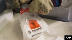 FILE - A batch of an experimental Ebola vaccine arrives at Geneva University Hospital, as shown in this photo released by the World Health Organization, Oct. 22, 2014.