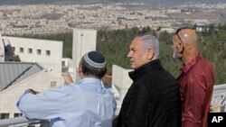 Israeli Prime Minister Benjamin Netanyahu, center, meets with heads of Israeli settlement officials in the occupied the West Bank, Tuesday, Nov. 19, 2019. (Menahem Kahana/ Pool via AP)