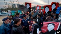 Pakistani human rights activists talk to police officers during a rally against missing people in Islamabad, Pakistan.