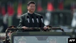 FILE - China's President Xi Jinping inspects People's Liberation Army soldiers at a barracks in Hong Kong, June 30, 2017.