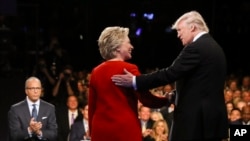 Democratic presidential nominee Hillary Clinton and Republican presidential nominee Donald Trump shake hands during the presidential debate at Hofstra University in Hempstead, N.Y., Monday, Sept. 26, 2016. (Joe Raedle/Pool via AP)