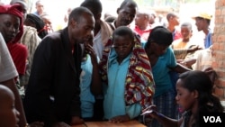 Burundian refugees, register with officials at a Bugesera reception center Eastern Rwanda. (Mohammed Yusuf for VOA)