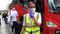 រូបឯកសារ៖ អ្នកដំណើរជនជាតិអង់គ្លេសដើរពីក្រោយបុគ្គលិកស្ថានទូត មុនពេលត្រូវបានបញ្ជូនទៅព្រលានយន្តហោះនៅក្រុងលីម៉ា ប្រទេសប៉េរូ កាលពីថ្ងៃទី២៥ ខែមីនា ឆ្នាំ២០២០។ 