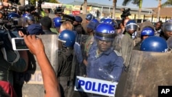 Riot police break up a press conference by opposition leader Nelson Chamisa in Harare, Zimbabwe, Aug. 3, 2018.