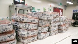 FILE - Packages of cocaine sit at a facility in Sydney, Australia, in this undated photo provided by Australian Federal Police on Jan. 18, 2018. Police said June 4, 2021, that they foiled a plan to bring nearly three tons of cocaine into Australia.