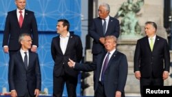 NATO Secretary General Jens Stoltenberg, Poland's President Andrzej Duda, Greek Prime Minister Alexis Tsipras, U.S. President Donald Trump, Portugal's Prime Minister Antonio Costa, Hungarian Prime Minister Viktor Orban pose for a group photo in the park of the Cinquantenaire, during a NATO Summit, in central Brussels, Belgium, July 11, 2018. 