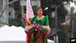 FILE - Philippine Vice President-elect Sara Duterte, daughter of outgoing populist president of the Philippines, delivers her speech during her oath-taking rites in her hometown in Davao city, southern Philippines, on June 19, 2022.