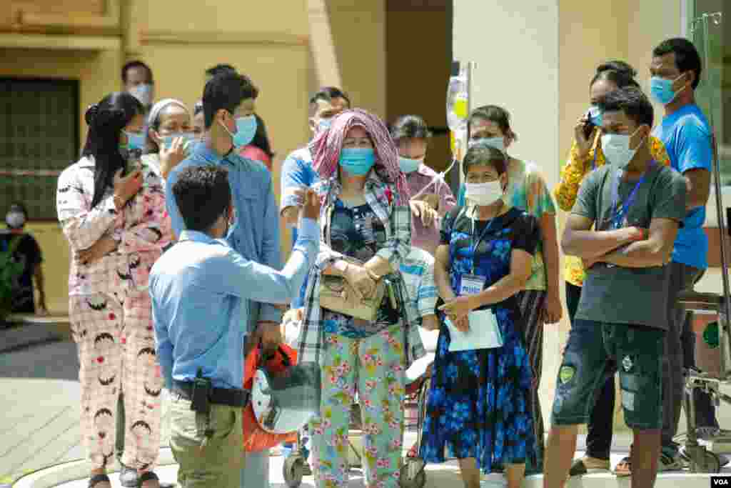 ពលរដ្ឋ​កម្ពុជា​មួយចំនួន​ ឈរ​មើល​លោក​នាយក​រដ្ឋមន្ត្រី​ ហ៊ុន សែន​ មក​ទទួល​​ការ​ចាក់​​វ៉ាក់សាំង​បង្ការ​ជំងឺ​កូវីដ១៩​​ របស់​ក្រុមហ៊ុន​ AstraZeneca​ នៅ​មន្ទីរពេទ្យ​កាល់ម៉ែត្រ​​ ភ្នំពេញ​ ថ្ងៃទី៤​ ខែមីនា​ ឆ្នាំ២០២១។​ (ហ៊ាន សុជាតា/​វីអូអេ​)