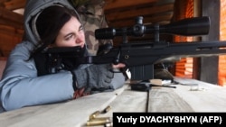 People take part in a training course at a shooting complex outside Lviv, Ukraine, on February 22, 2022. (Yuriy DYACHYSHYN / AFP)