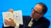In this Feb. 9, 2021, file photo, Peter Ben Embarek of the World Health Organization team holds up a chart showing pathways of transmission of the virus during a joint news conference at the end of the WHO mission in Wuhan in central China's Hubei provinc