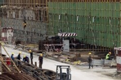 FILE - Chinese workers are seen at the construction site of the new Great Mosque, which is being built by the China State Construction Engineering Corporation (CSCEC), in Algiers, Algeria, Jan. 20, 2016.