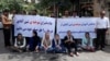 Female victims of a 2012 school fire in the northwestern Iranian city of Shinabad and their supporters stage a protest outside the Tehran office of President Hassan Rouhani, July 18, 2018.
