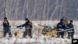 Personnel work at the scene of the AN-148 plane crash near Stepanovskoye, about 40 kilometers (25 miles) from the Domodedovo airport, Russia, Feb. 12, 2018. The plane carrying 71 people crashed Sunday near Moscow, killing everyone aboard.