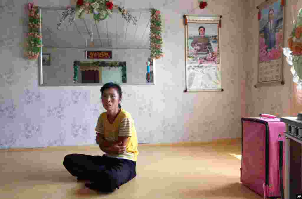 Farmer O Yong Ae sits at her home in North Korea. Farmers would be able to keep a bigger share of their crops under proposed changes aiming to boost production by North Korea's collective farms.