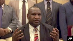 Papua New Guinea's new Prime Minister James Marape speaks to media after being sworn in, Thursday, May 30, 2019, in Port Moresby, Papua New Guinea. 