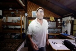 Evan Harris prepares his property to minimize the fire impact at Burragate, Australia, Jan. 10, 2020, as a nearby fire threatens the area.