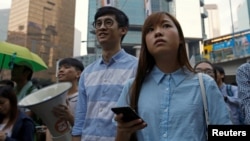 Anggota parlemen terpilih pro-kemerdekaan Baggio Leung (Tengah) dan Yau Wai-ching (kanan) ikut serta dalam unjuk rasa menentang apa yang mereka sebut campur tangan Beijin terhadap politik lokal dan aturan hukum. (foto: REUTERS/Tyrone Siu)