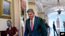Sen. Joe Manchin, D-W.Va., walks to a caucus lunch at the Capitol in Washington, Dec. 17, 2021. 