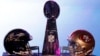 The helmets of the San Francisco 49ers and the Baltimore Ravens sit beside the Vince Lombardi trophy before a press conference ahead of the NFL's Super Bowl XLVII in New Orleans, Louisiana, Feb. 1, 2013. 