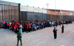 FILE - The U.S. Customs and Border Protection detains migrants who crossed the U.S.-Mexico border in El Paso, Texas, May 29, 2019.