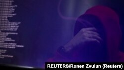 A man is reflected in a monitor as he takes part in a training session at Cybergym, a cyber-warfare training facility backed by the Israel Electric Corporation, at their training center in Hadera, Israel July 8, 2019. Picture taken July 8, 2019. REUTERS/Ronen Zvulun