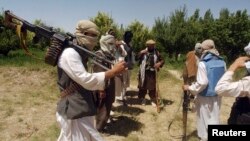 FILE - Taliban fighters are seen in an undisclosed location in Afghanistan, July 14, 2009.