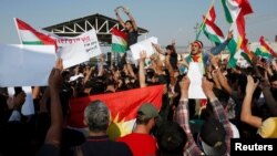 Syrian Kurds protest the Turkish offensive against Syria during a demonstration in front of the United Nation Headquarter in Erbil, Iraq Oct. 10, 2019. 