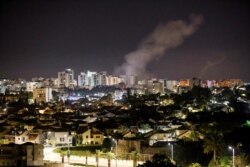 Smoke rises over houses in Ashkelon following a rocket attack launched from Gaza toward Ashkelon, southern Israel, May 14, 2021.