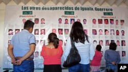 FILE - Photographs of the missing are on display at the future site of the Victims' City in Iguala, Guerrero State, Mexico, Nov. 22, 2016.