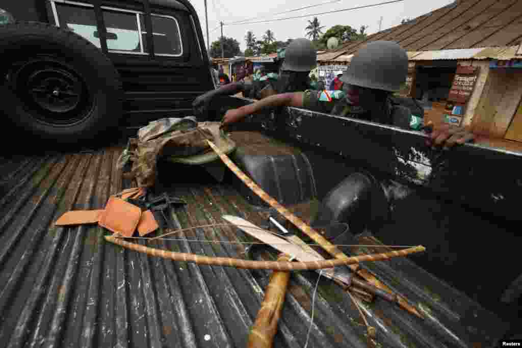 African peace keeping soldiers check confiscated traditional weapons during a patrol in the pro-Christian area of Bangui, Feb. 15, 2014. 