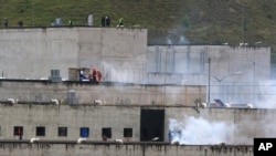 Tear gas rises from parts of Turi jail where an inmate riot broke out in Cuenca, Ecuador, Feb. 23, 2021. 