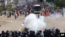 FILE - Riot police battle protesters teachers who blocked a federal highway in the Mexican state of Oaxaca, near the town of Nochixtlan, June 19, 2016.