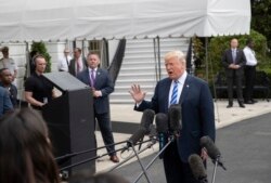 FILE - President Donald Trump talks to the media at the White House as he leaves for Dallas to address the National Rifle Association, May 4, 2018.