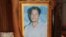 An unknown person holds a photo of Tuy Sros, 34, in a home in Banteay Meanchey province's Ou Chrov district's Chrey village, Phnom Penh, Cambodia, January 20, 2020. (Sun Narin/VOA Khmer) 