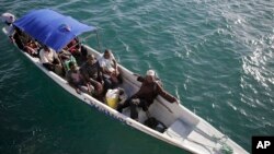 Fishermen head out to sea for their daily catch on June 10, 2022 at Shimoni Port in Kenya. (AP Photo/Brian Inganga)