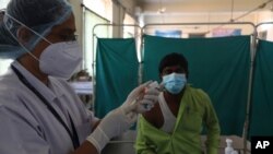A health worker participates in a COVID-19 vaccine delivery system trial in Hyderabad, India, Jan. 2, 2021.