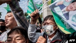 Supporters of the ruling Democratic Progressive Party (DPP) react during a campaign motorcade tour of Taiwan vice president and presidential candidate Lai Ching-te in Kaohsiung on Jan. 8, 2024, ahead of the presidential election.