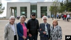 From left, Sonja Sternberg, her sister Gisela Feldman, Thomas Jacobson, Sonja Geismar, Eva Wiener passengers from the 1939 SS St. Louis trans-Atlantic ship, pose for a photograph during a visit to the Yad Vashem Holocaust memorial in Jerusalem, Nov. 17, 2016.