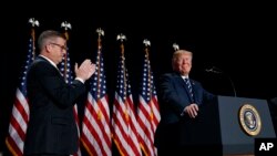 Rep. Randy Hultgren, R-Ill., applauds as President Donald Trump arrives to speak during the National Prayer Breakfast, Feb. 8, 2018, in Washington. 
