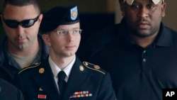 FILE - Army Pfc. Bradley Manning, now called Chelsea, is escorted to a security vehicle outside a courthouse in Fort Meade, Maryland, Aug. 20, 2013.