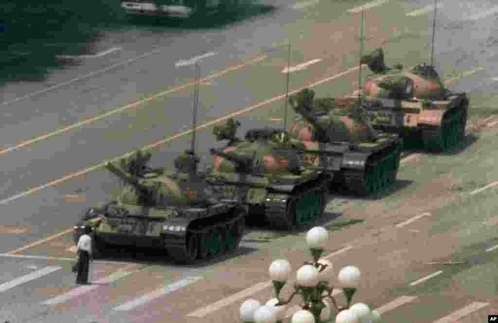 A man stands alone to block a line of tanks heading east on Beijing's Cangan Blvd. in Tiananmen Square, June 5, 1989.