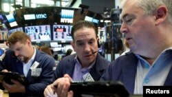 Traders work on the floor of the New York Stock Exchange in New York City, June 10, 2016.