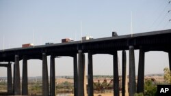 Traffic moves along a bridge as seen from a train in New Jersey, May 18, 2021.