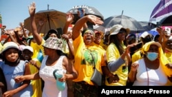 Members of the African National Congress (ANC) react to the arrival of South African President Cyril Ramaphosa during their party’s door-to-door political campaign ahead of the local government elections in Mabopane township north of Pretoria, Oct. 15, 2021.