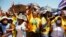 Members of the African National Congress (ANC) react to the arrival of South African President Cyril Ramaphosa during their party’s door-to-door political campaign ahead of the local government elections in Mabopane township north of Pretoria, Oct. 15, 2021.