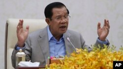 FILE - Cambodia's Prime Minister Hun Sen gestures during a speech on the current state of a new virus from China in Phnom Penh, Cambodia, Thursday, Jan. 30, 2020.