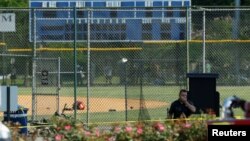 FILE - Police investigate a shooting scene after a gunman opened fire on Republican members of Congress during a baseball practice near Washington in Alexandria, Virginia, June 14, 2017. 