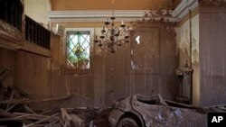 A car, dragged inside a church by a mudslide, is seen in Nova Friburgo, Brazil, 21 Jan 2011.